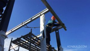 A Chinese construction worker on a prefabricated resort home.