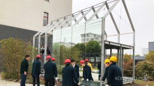 The mirrors are moved into place on a prefabricated aluminium cabin.