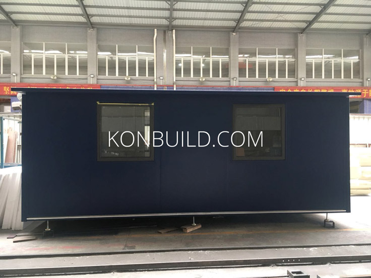 Side view of a shipping container home under construction.