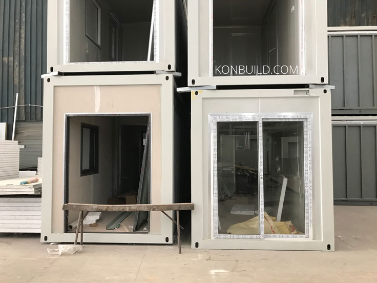 4 container homes stacked on top of each other during construction.